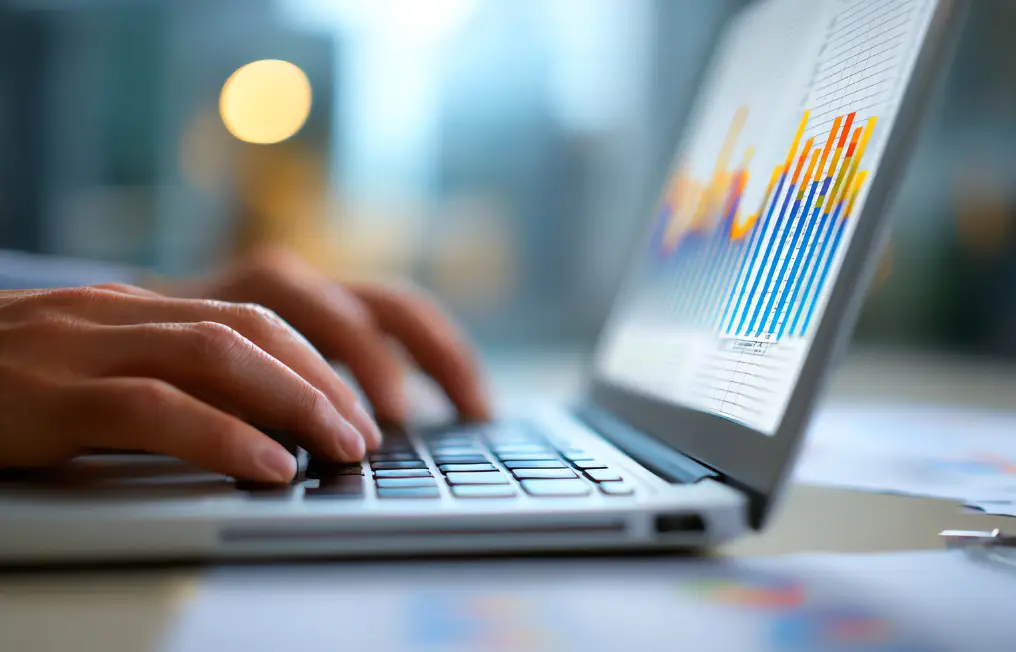 person typing on laptop and viewing analytics report
